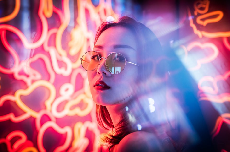 Young woman neon portrait at night with red lights in Chengdu, Sichuan province, China / Model: Fanny