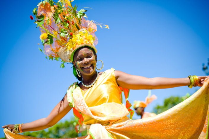 Young woman dancing in the streets of Paris at the annual summer tropical carnival, France