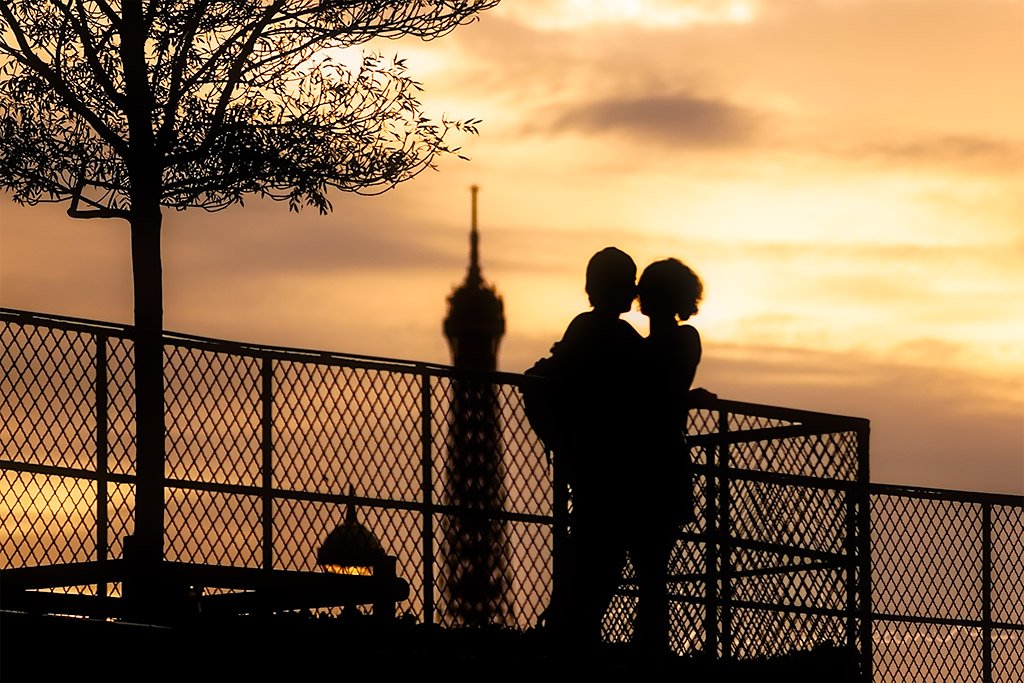 Young couple silhouette in Paris with the Eiffel tower in the background