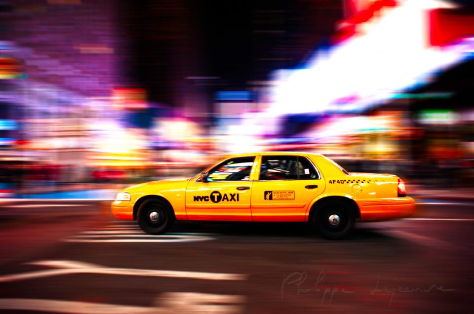 Yellow taxi at night in New York City, USA
