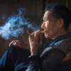 Portrait of an old chinese man smoking in an ancient tearoom in Chengdu, Sichuan Province, China