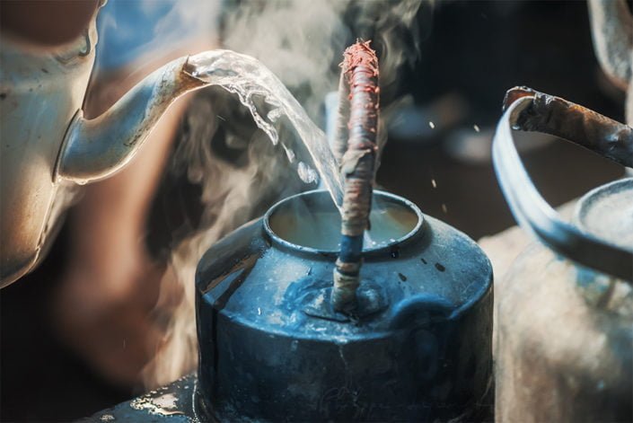 Boiling water pouring in a ancient teapot close-up view in Chengdu, Sichuan province, China