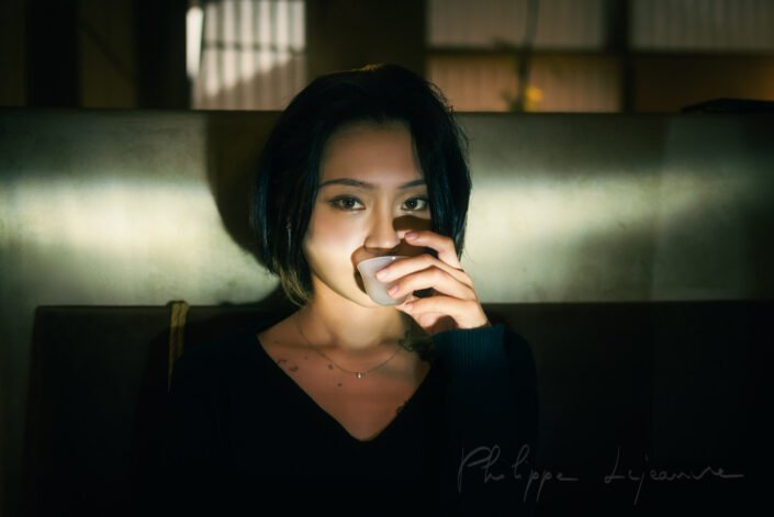Young woman drinking tea in a tearoom, Chengdu, Sichuan province, China