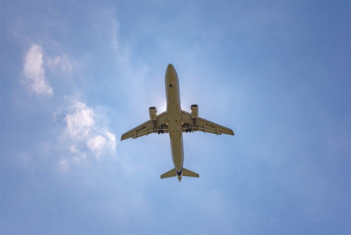 Commercial airplane against blue sky and sun in Chengdu, Sichuan province, China