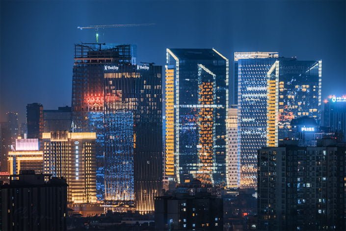 Fraser Suites and Wand buildings illuminated at night in Chengdu, Sichuan province, China