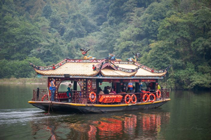 QingChengShan, Sichuan province, China - Sept 26, 2019 : Boat transporting chinese tourists on a lake.