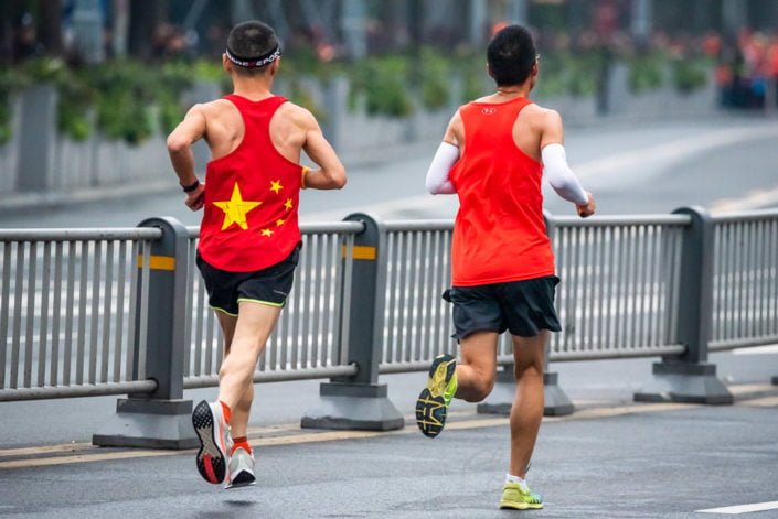 Chengdu, Sichuan province, China - Oct 27, 2019 : Two men with red t-shirts running at the Chengdu marathon