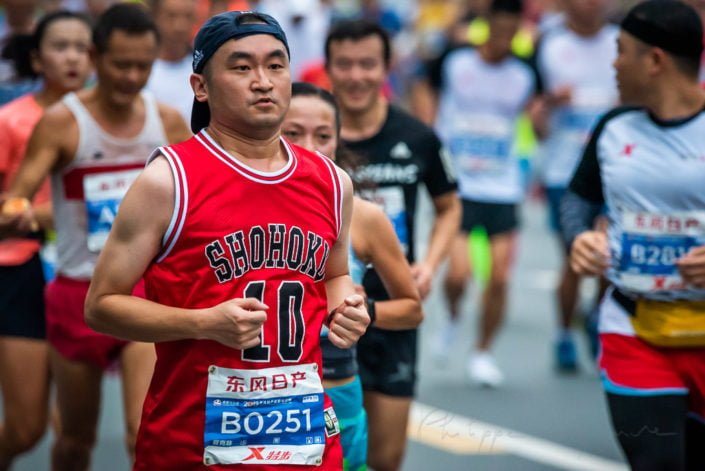 Chengdu, Sichuan province, China - Oct 27, 2019 : Young man running at the Chengdu marathon with a red basketball T-Shirt