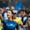 Chengdu, Sichuan province, China - Oct 27, 2019 : Young woman with a captain america T-Shirt taking a selfie at the Chengdu Marathon