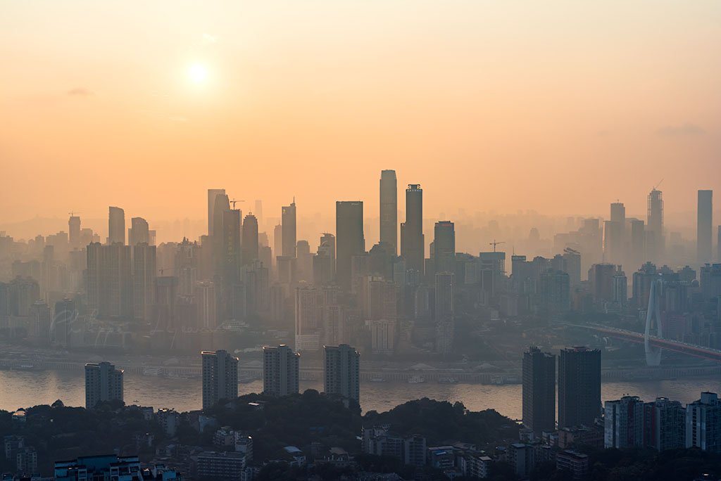 Chongqing skyline aerial view in the haze against sun, China