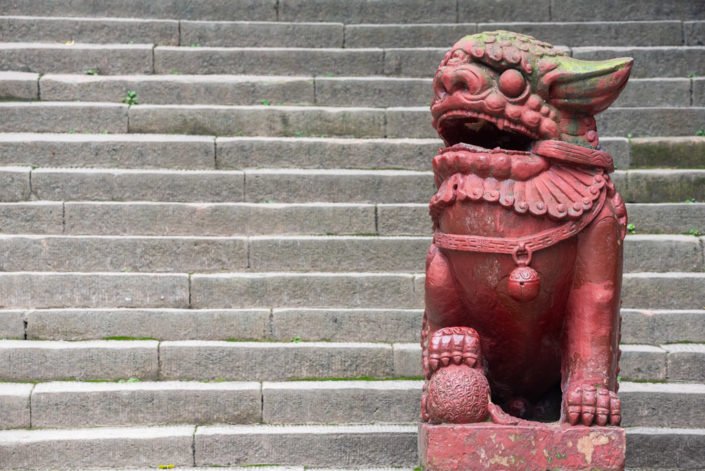 Dragon son red statue on stairs in QingCheng mountain, Sichuan province, China