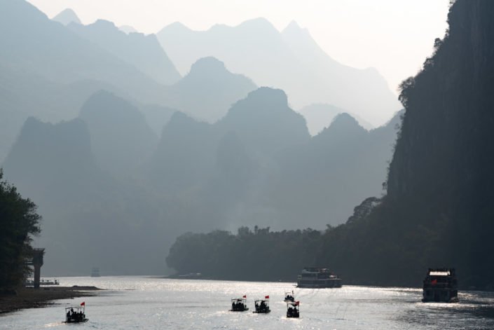 Li River cruise between Guilin and Yangshuo with limestone karst hills foggy landscape in Guangxi province, China