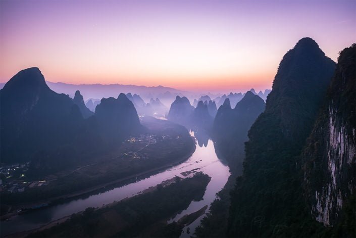 Mountain landscape in the mist at dawn with Li river in Xingping, Yangshuo, Guilin, Guangxi province, China