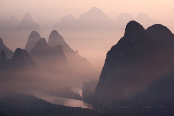 Mountain landscape in the mist at dawn with Li river in Xingping, Yangshuo, Guilin, Guangxi province, China