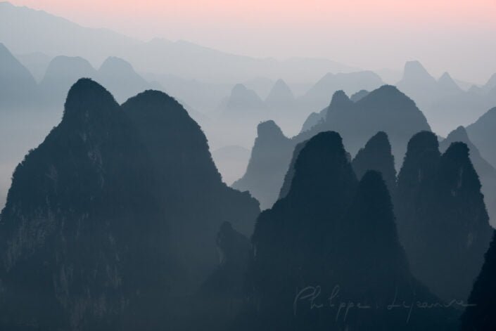 Sunrise behind mountains range landscape from XiangGong Hill in Xingping, Yangshuo, Guilin, Guangxi province, China