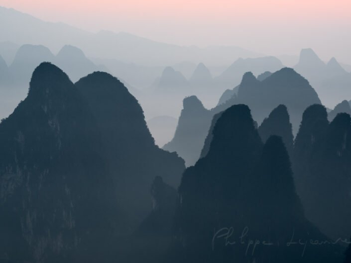 Sunrise behind mountains range landscape from XiangGong Hill in Xingping, Yangshuo, Guilin, Guangxi province, China