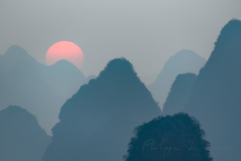 Sunrise behind mountains landscape in Xingping, Yangshuo, Guilin, Guangxi province, China