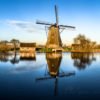 Windmill reflecting in water in Kinderdijk, Rotterdam, Netherlands
