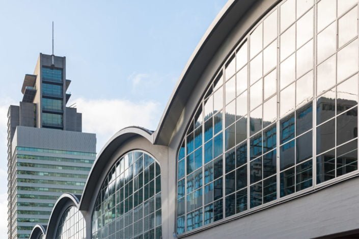 Rotterdam, Netherlands : Rotterdam cruise terminal arch windows with buildings in the background in Wilhelminapier district.