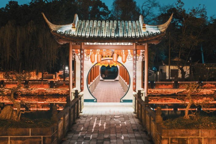 Baihuatan chinese traditional bridge illuminated with chinese lanterns at night in Chengdu, Sichuan province, China