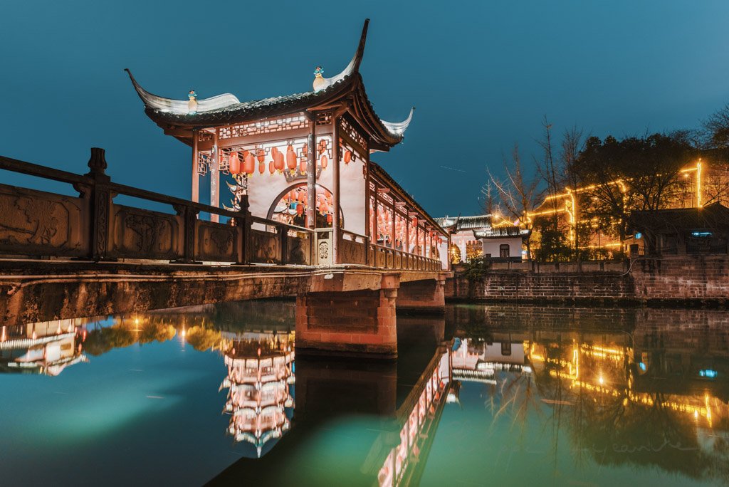 Baihuatan chinese traditional bridge illuminated with chinese lanterns at night in Chengdu, Sichuan province, China