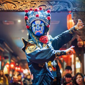 Chengdu, Sichuan Province, China : Chinese actor performs a public traditional face-changing art or bianlian onstage at Chunxifang Chunxilu covered street.