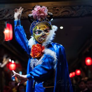 Chinese actor performs a public traditional face-changing art or bianlian onstage at Chunxifang Chunxilu covered street, Chengdu, Sichuan province, China