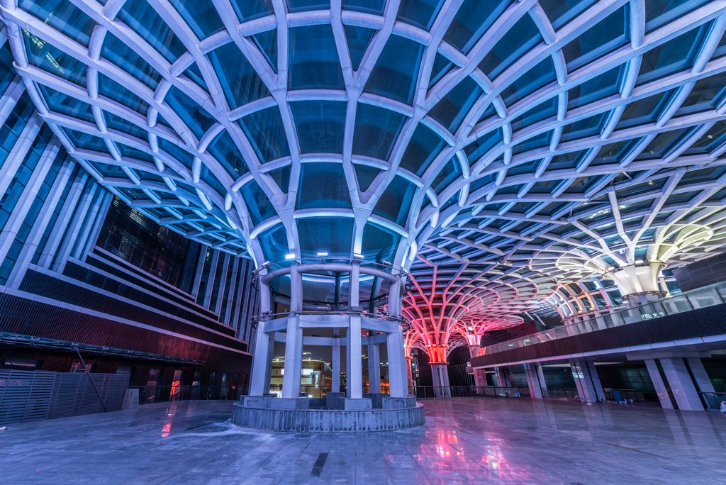 Umbrella shape architectural feature illuminated with multicolor lights at night in XinNanZhongXin building, Chengdu, Sichuan province, China