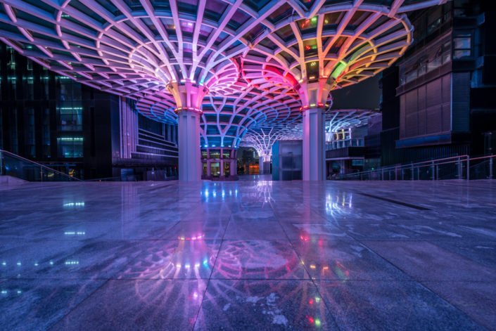 Umbrella shape architectural feature illuminated with multicolor lights at night in XinNanZhongXin building, Chengdu, Sichuan province, China
