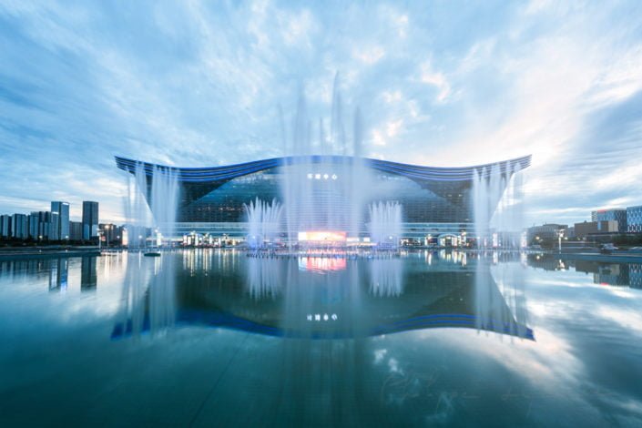 New Century Global Center reflecting in a basin with fountains at sunset, Chengdu, Sichuan Province, China
