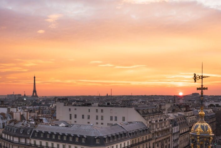 Paris roofs and Eiffel tower aerial view at sunset, France