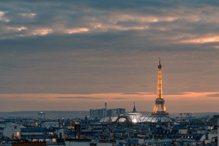 Paris skyline at sunsret with illuminated Grand Palais and Eiffel tower, France