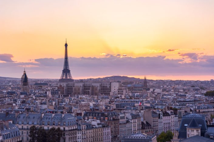 Paris skyline with Eiffel tower aerial view at sunset - purple colors, France