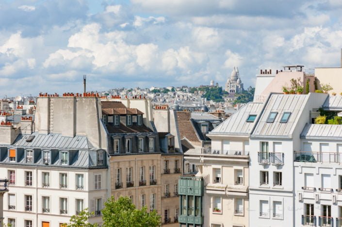 Parisian buildings with montmartre and the sacre-coeur in the background, Paris, France