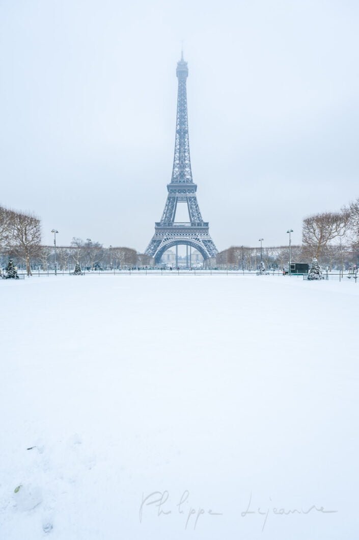 Eiffel tower under the snow in winter from the Champs de Mars in Paris, France