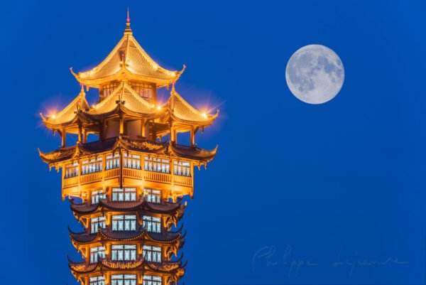 JiuTian tower illuminated at night and moon in Chengdu, sichuan province, China