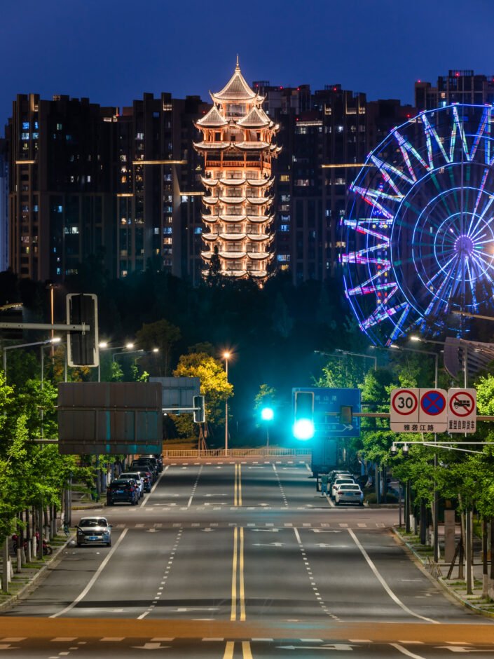 Jiutian tower illuminated at night and Ferris wheel in Chengdu, Sichuan province, China