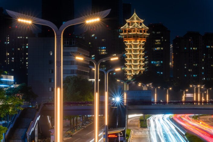 Jiutian tower illuminated at night and car traffic in Chengdu, Sichuan province, China