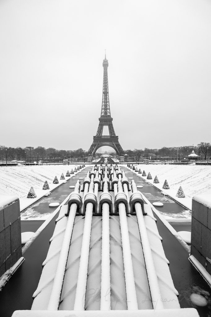 Eiffel tower under the snow from the gardens of the trocadero in Paris - black and white