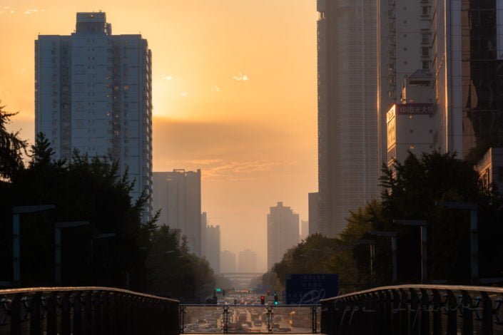 Foot bridge against sunrise in downtown Chengdu city