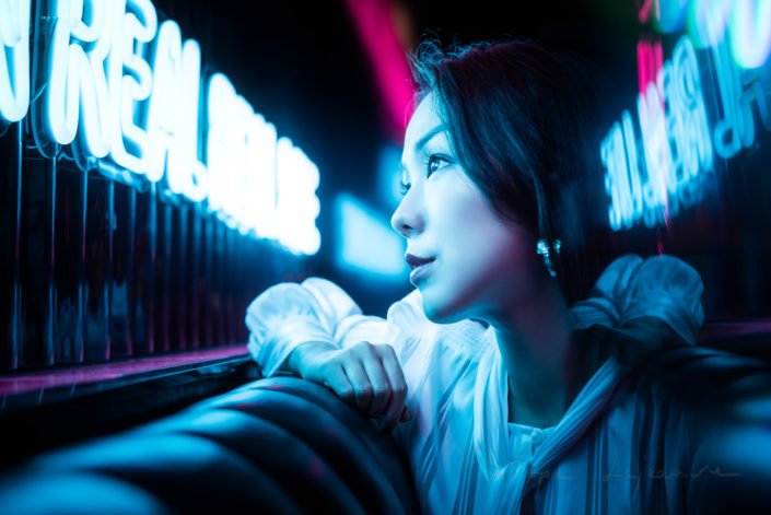 Young Chinese woman portrait with neon lights, Chengdu, Sichuan province, China