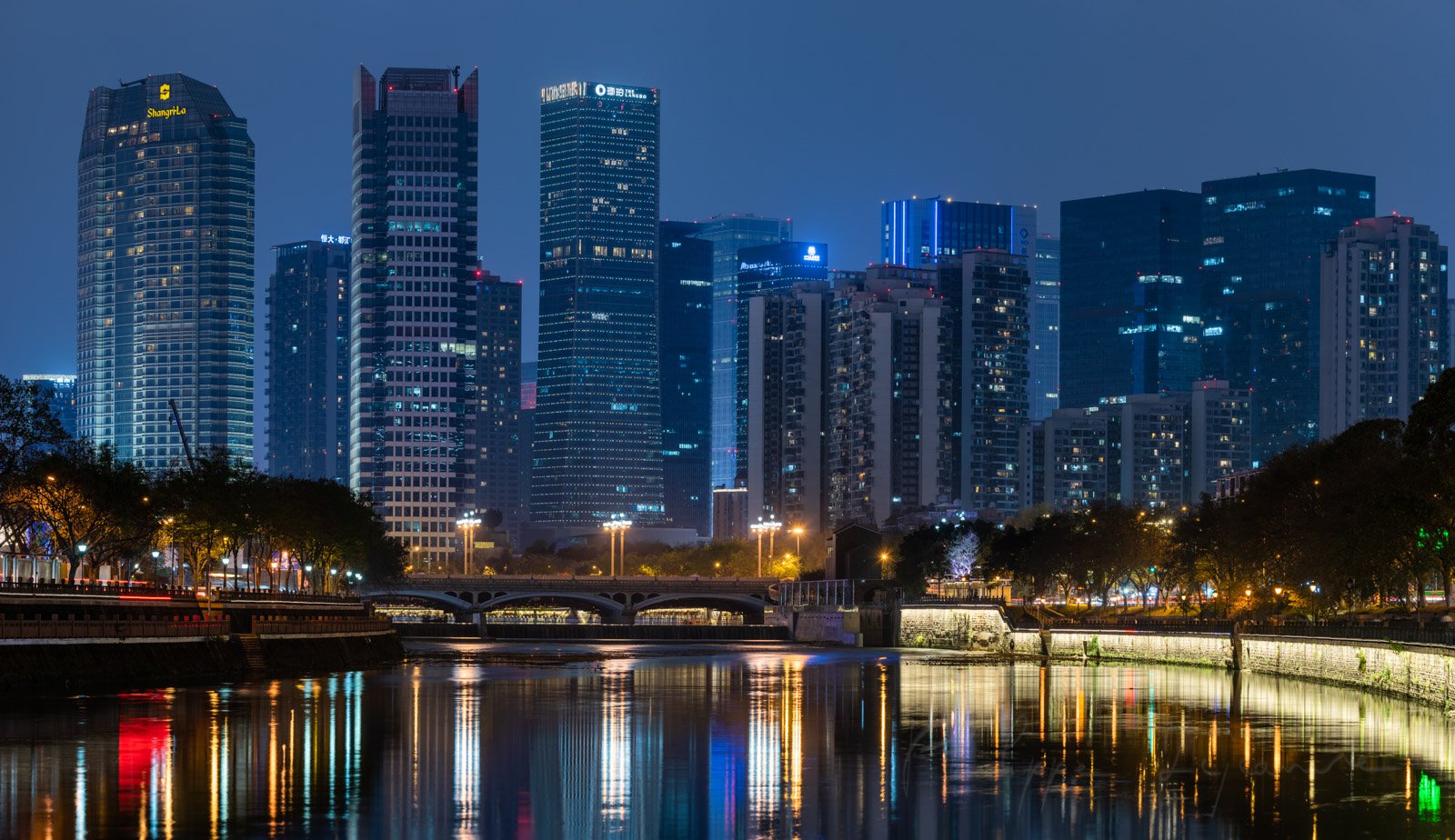 Chengdu city center skyline at night from Jinjiang river banks, Sichuan province, China