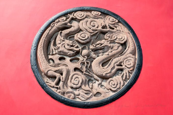 Chinese dragon bas-relief on the Daci buddhist temple red wall in downtown Chengdu, Sichuan province, China