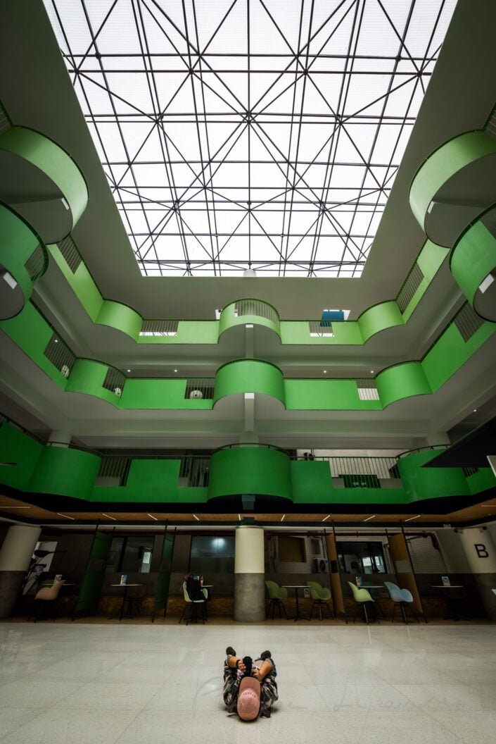 Modern building green atrium directly below view with natural light coming from transparent ceiling