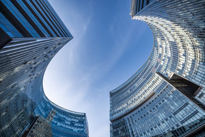 Modern curved glass buildings against clear blue sky, Chengdu, Sichuan province, China