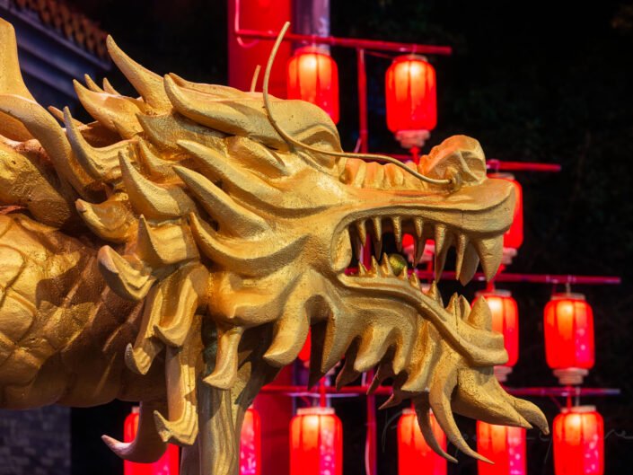 Dragon sculpture illuminated at night with red Chinese lanterns for the year of the dragon in Chengdu, Sichuan province, China