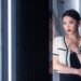 Young chinese woman standing next to white neon lights in Chengdu, Sichuan province, China